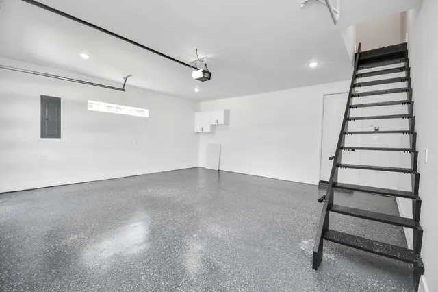 a view of empty room with wooden floor and ceiling fan
