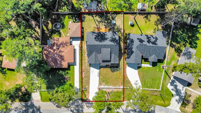 an aerial view of a house with swimming pool and outdoor space