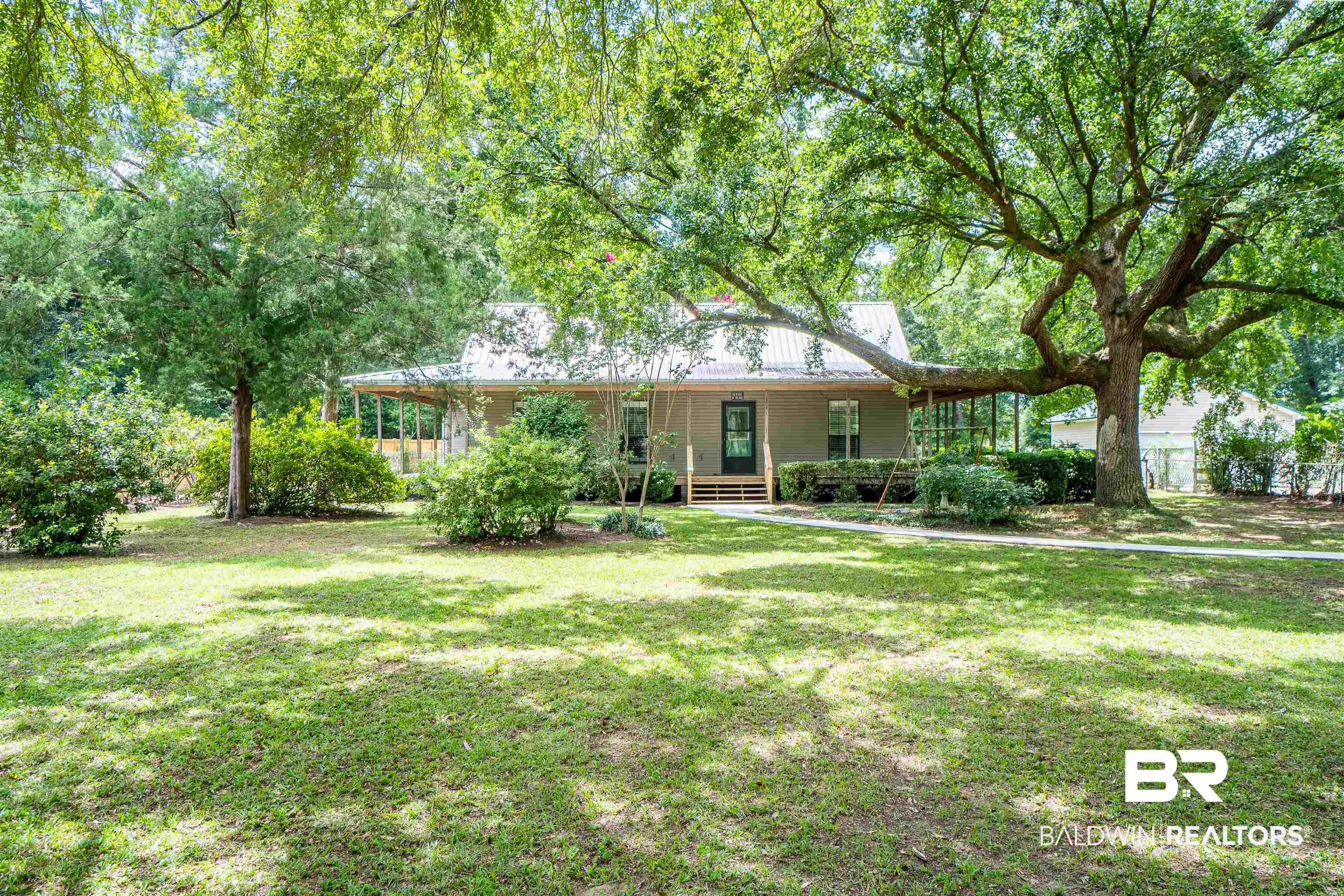 Ranch-style house with a front lawn and covered porch