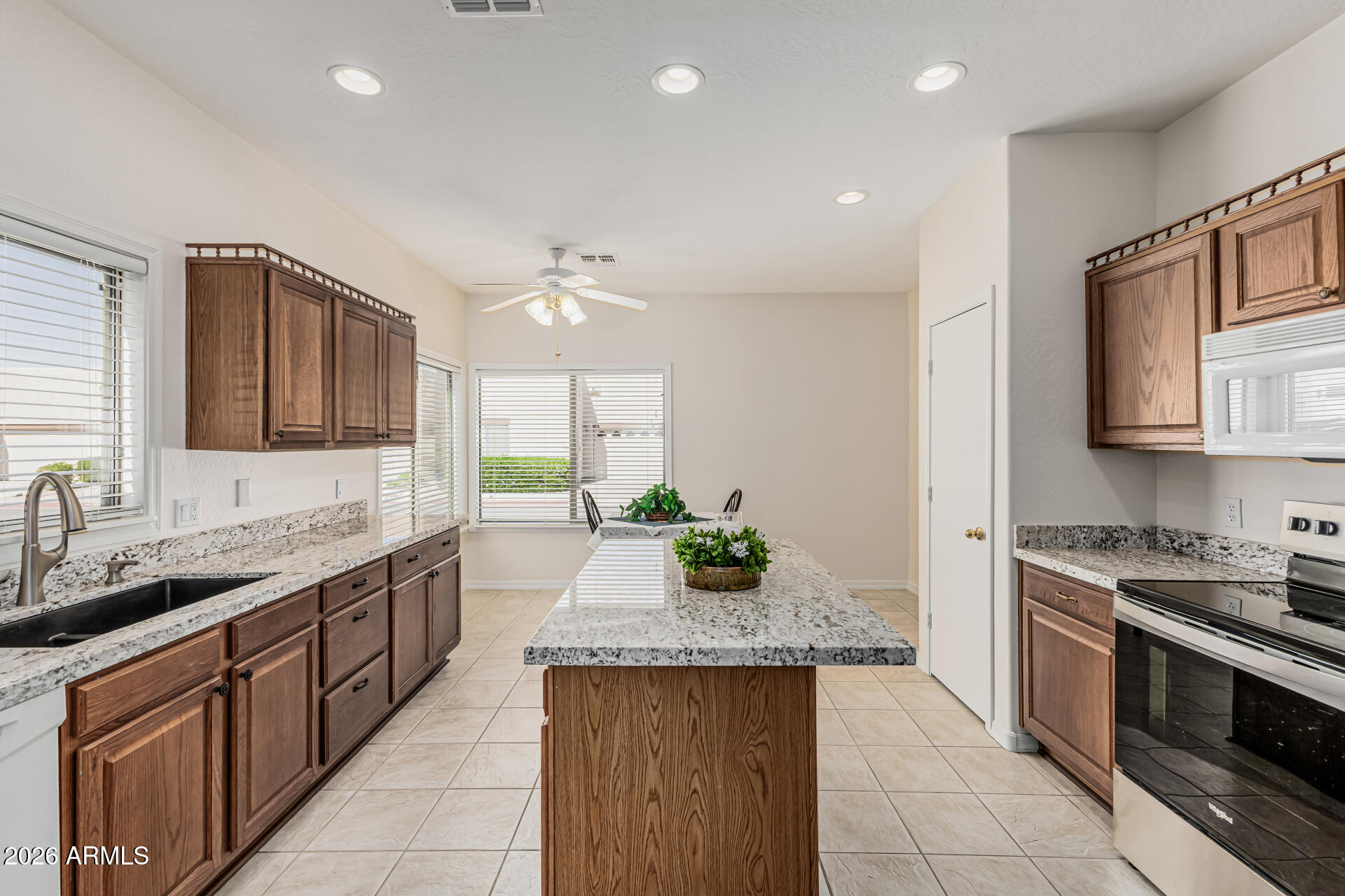 1650 South Crismon Road, Unit 16 Mesa, AZ 85209 - Photo 15 of 39 a kitchen with a sink stove and cabinets