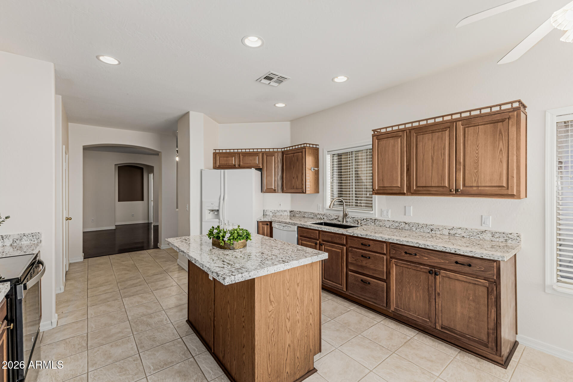1650 South Crismon Road, Unit 16 Mesa, AZ 85209 - Photo 16 of 39 a kitchen with granite countertop a sink and cabinets