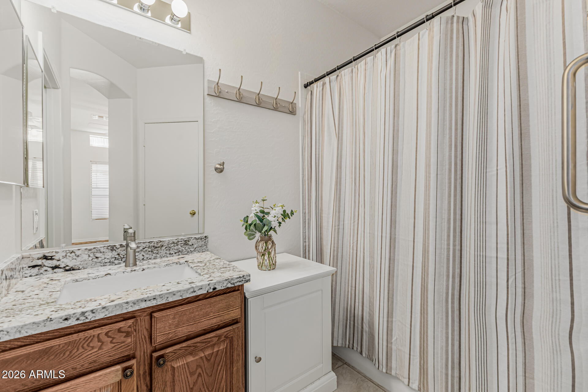 1650 South Crismon Road, Unit 16 Mesa, AZ 85209 - Photo 20 of 39 a bathroom with a granite countertop sink and a mirror