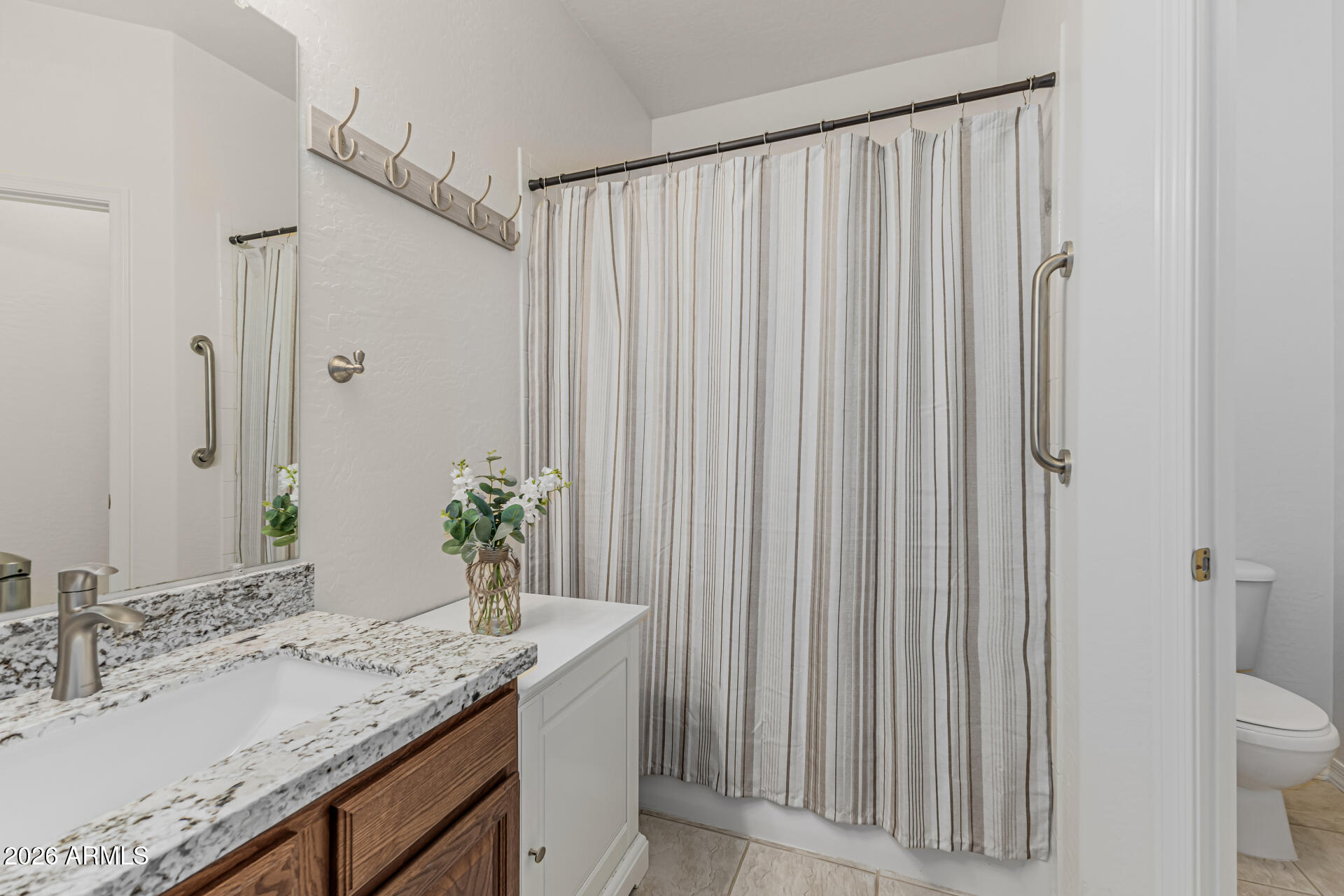 1650 South Crismon Road, Unit 16 Mesa, AZ 85209 - Photo 22 of 39 a bathroom with a granite countertop sink and a mirror