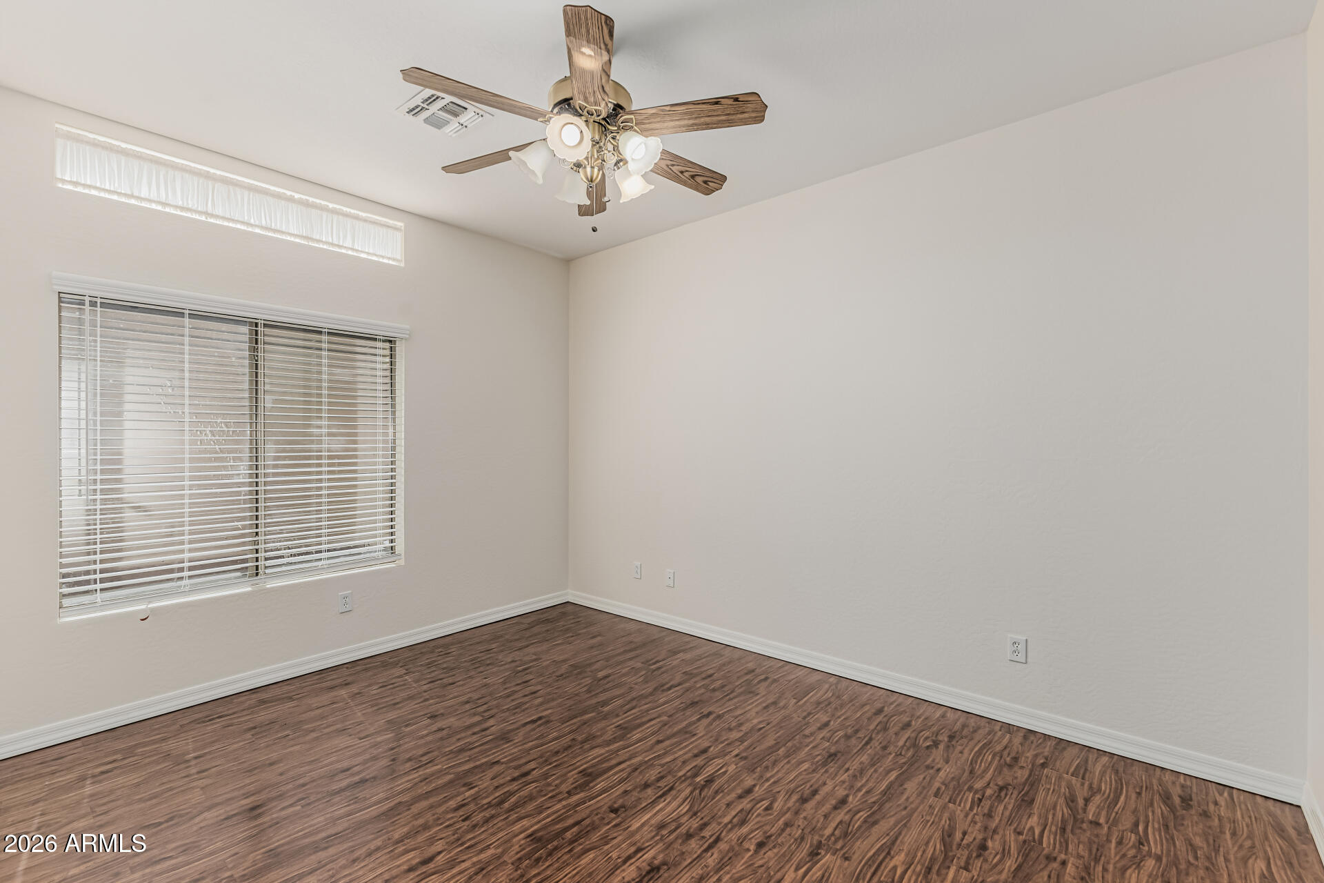 1650 South Crismon Road, Unit 16 Mesa, AZ 85209 - Photo 23 of 39 wooden floor in an empty room with a window