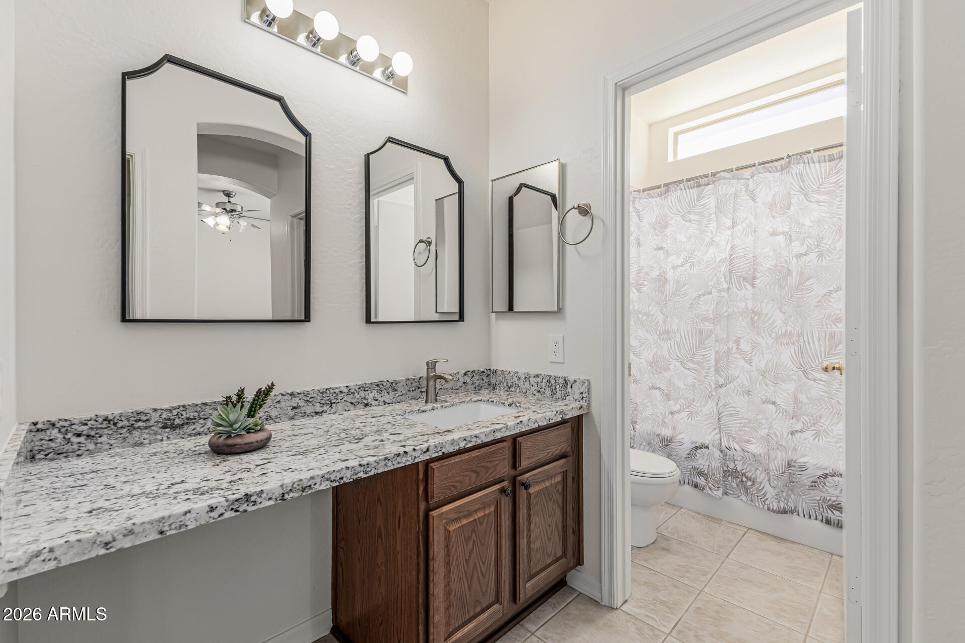 1650 South Crismon Road, Unit 16 Mesa, AZ 85209 - Photo 26 of 39 a bathroom with a granite countertop sink a mirror and shower
