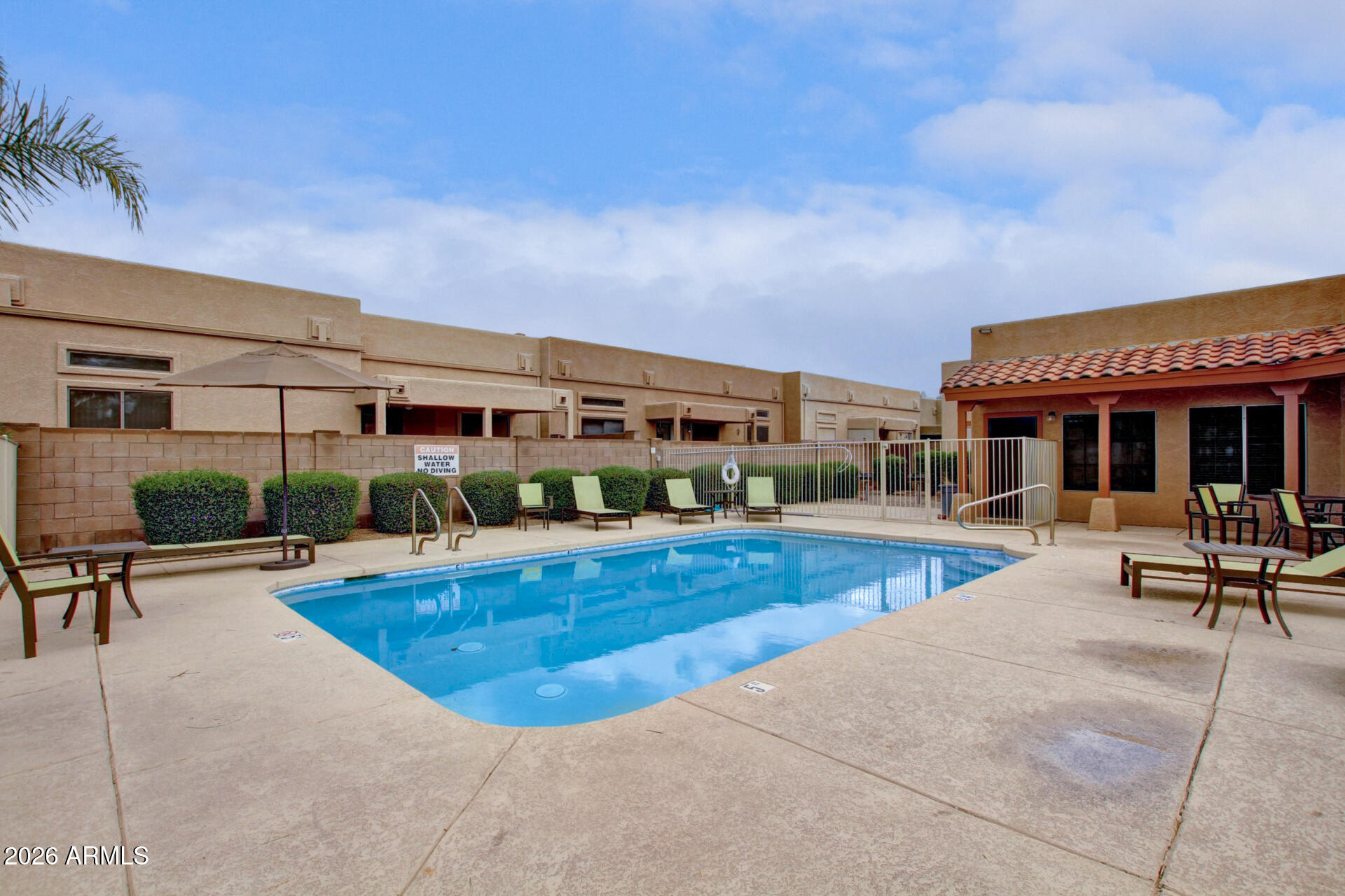 1650 South Crismon Road, Unit 16 Mesa, AZ 85209 - Photo 38 of 39 a view of a swimming pool with outdoor seating