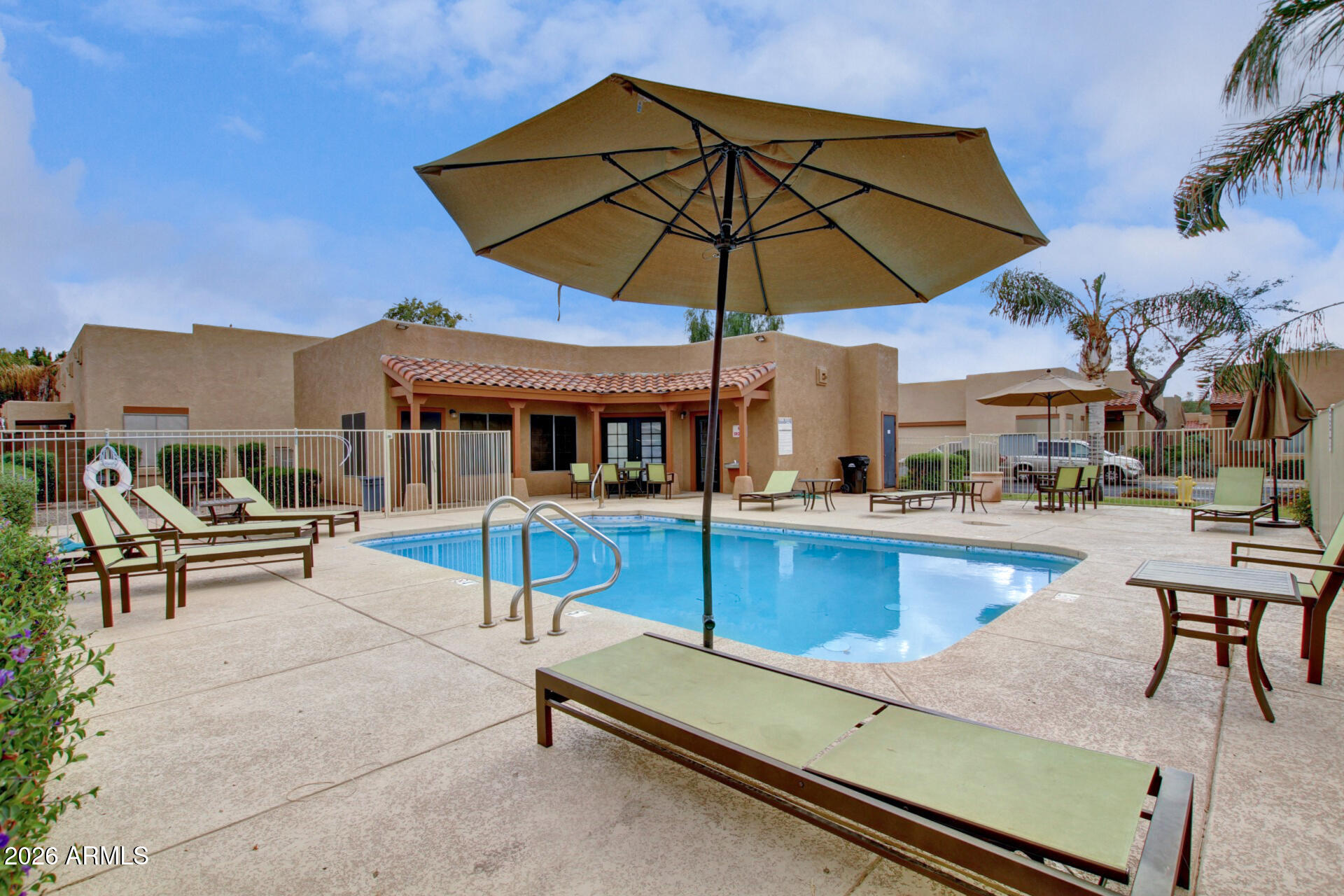 1650 South Crismon Road, Unit 16 Mesa, AZ 85209 - Photo 39 of 39 deck with table and chairs under an umbrella