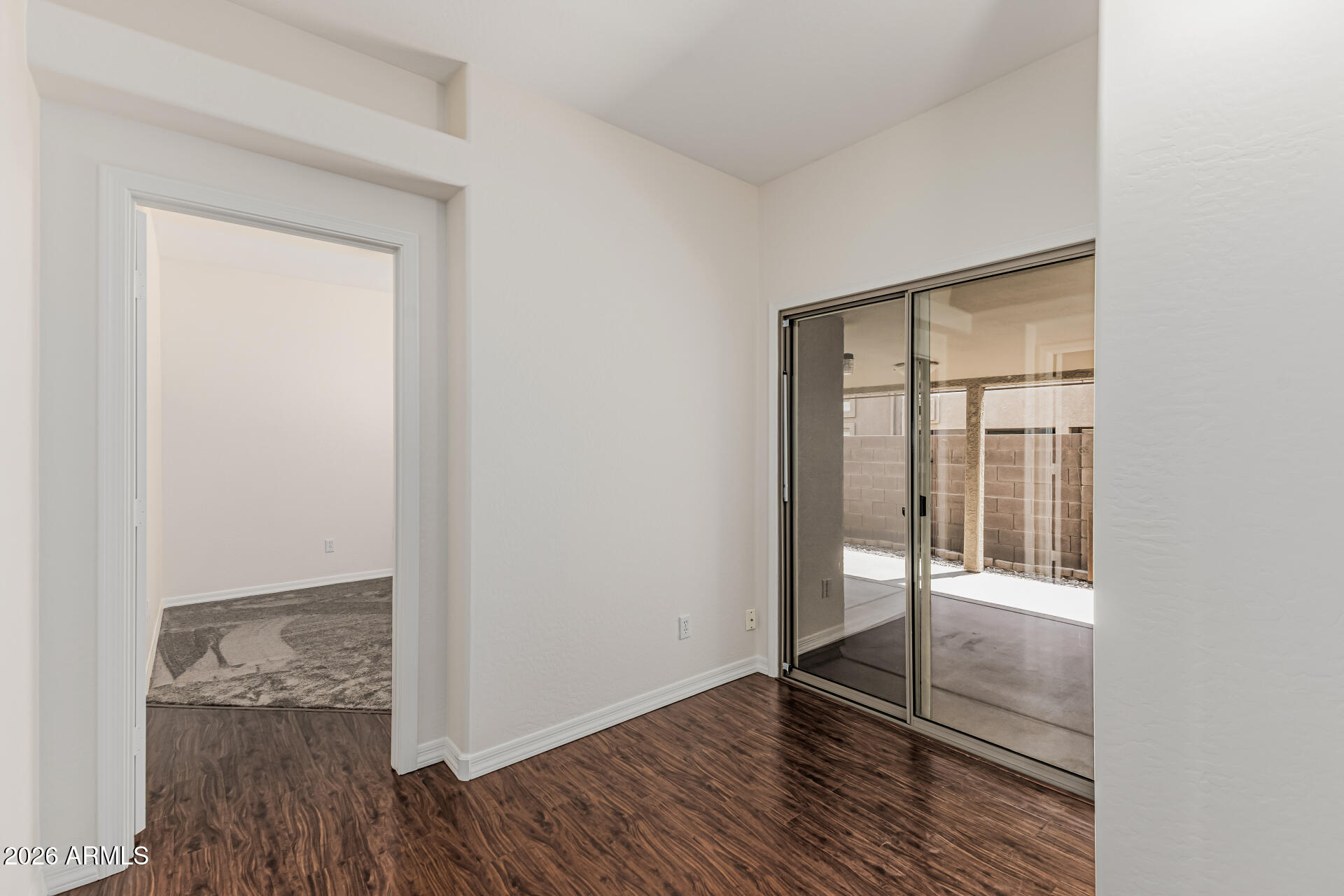 1650 South Crismon Road, Unit 16 Mesa, AZ 85209 - Photo 10 of 39 an empty room with wooden floor and windows