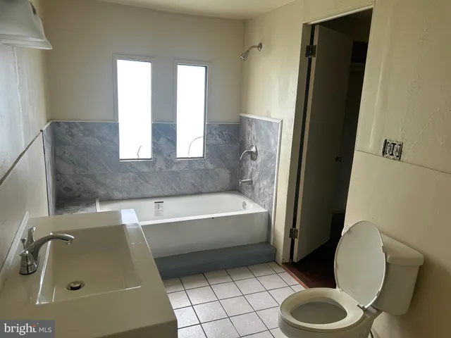 a bathroom with a bathtub a toilet and a sink