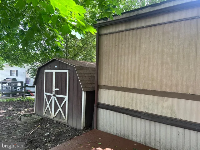 a view of a small house with wooden fence