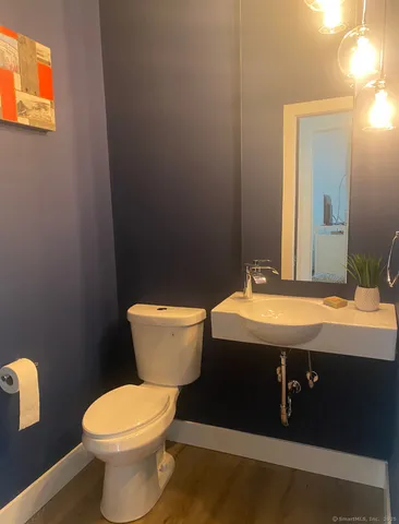a bathroom with a granite countertop toilet and a sink