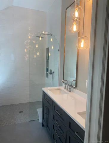 a bathroom with a sink double vanity and a mirror