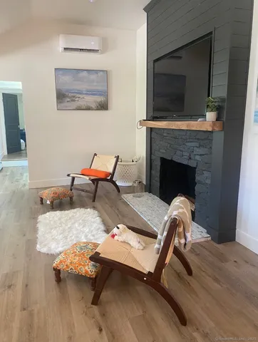 a living room with furniture fireplace and flat screen tv