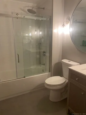a bathroom with a toilet and a shower