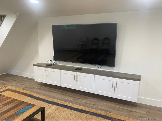 a living room with hard wood floors and a fireplace