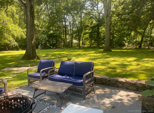 a view of a swimming pool with chair and table or chairs