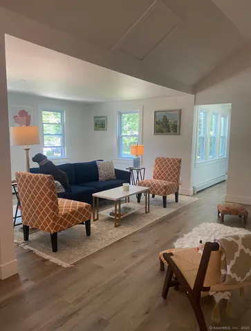a living room with furniture and wooden floor