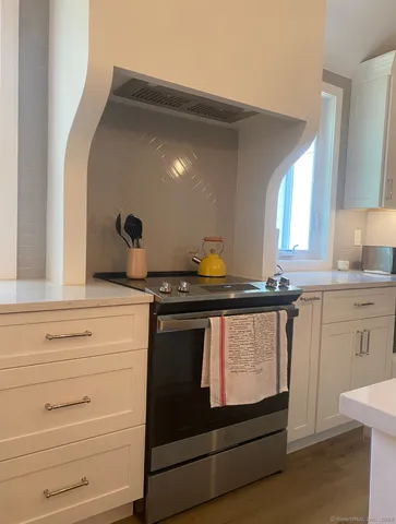 a kitchen with a stove and a mirror