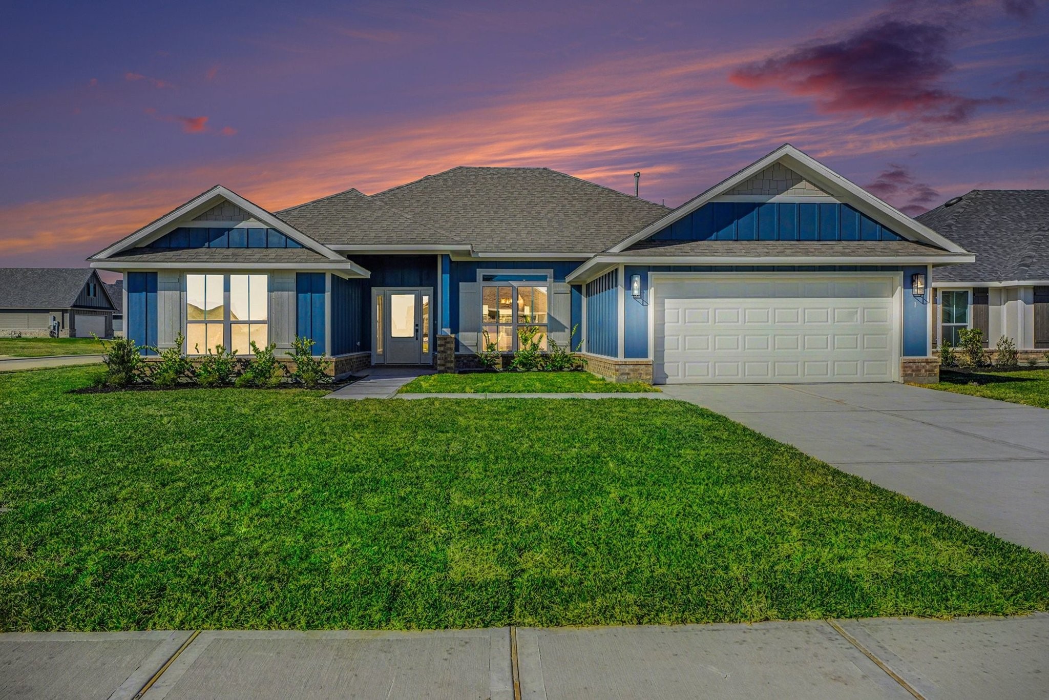 a front view of a house with a garden and plants