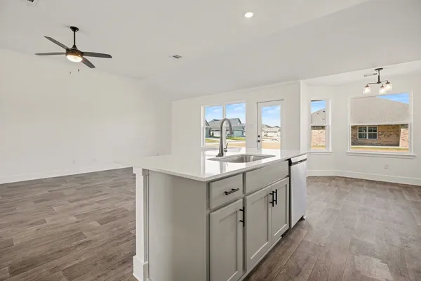 a kitchen with granite countertop a stove and a sink