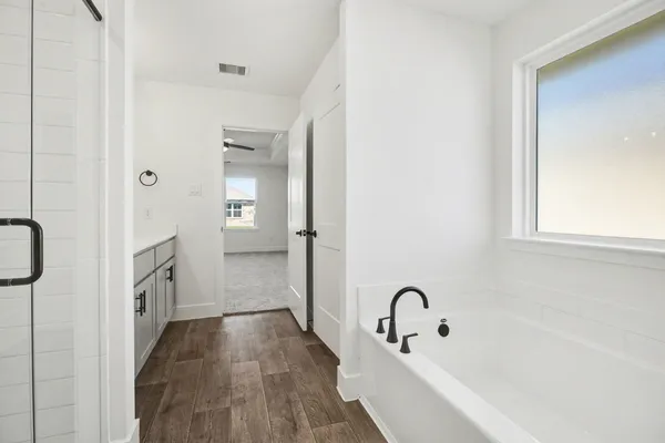 a bathroom with a bathtub and a sink