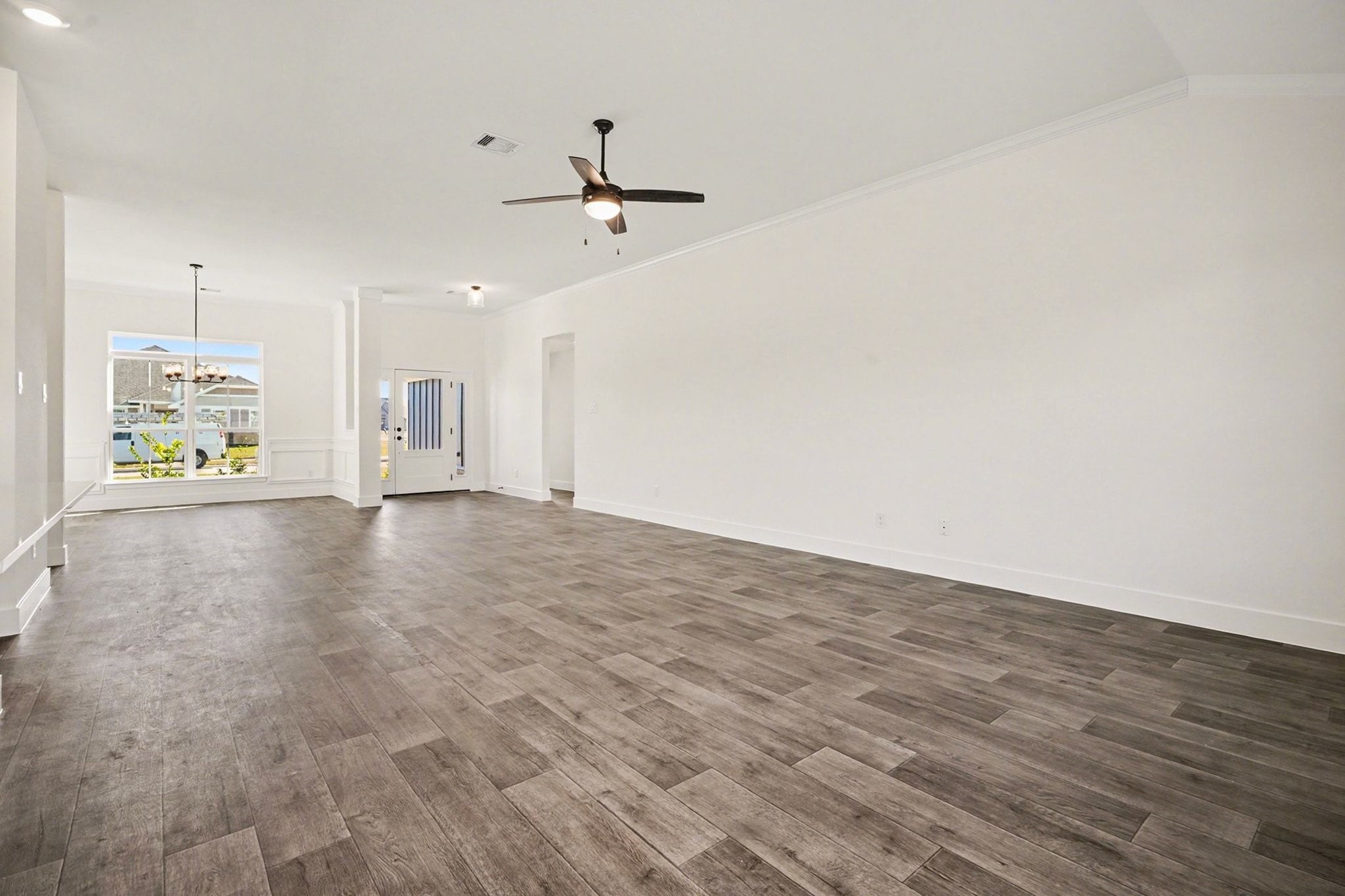 1 Keystone Court Angleton, TX 77515 - Photo 5 of 26 a view of an empty room with window and wooden floor
