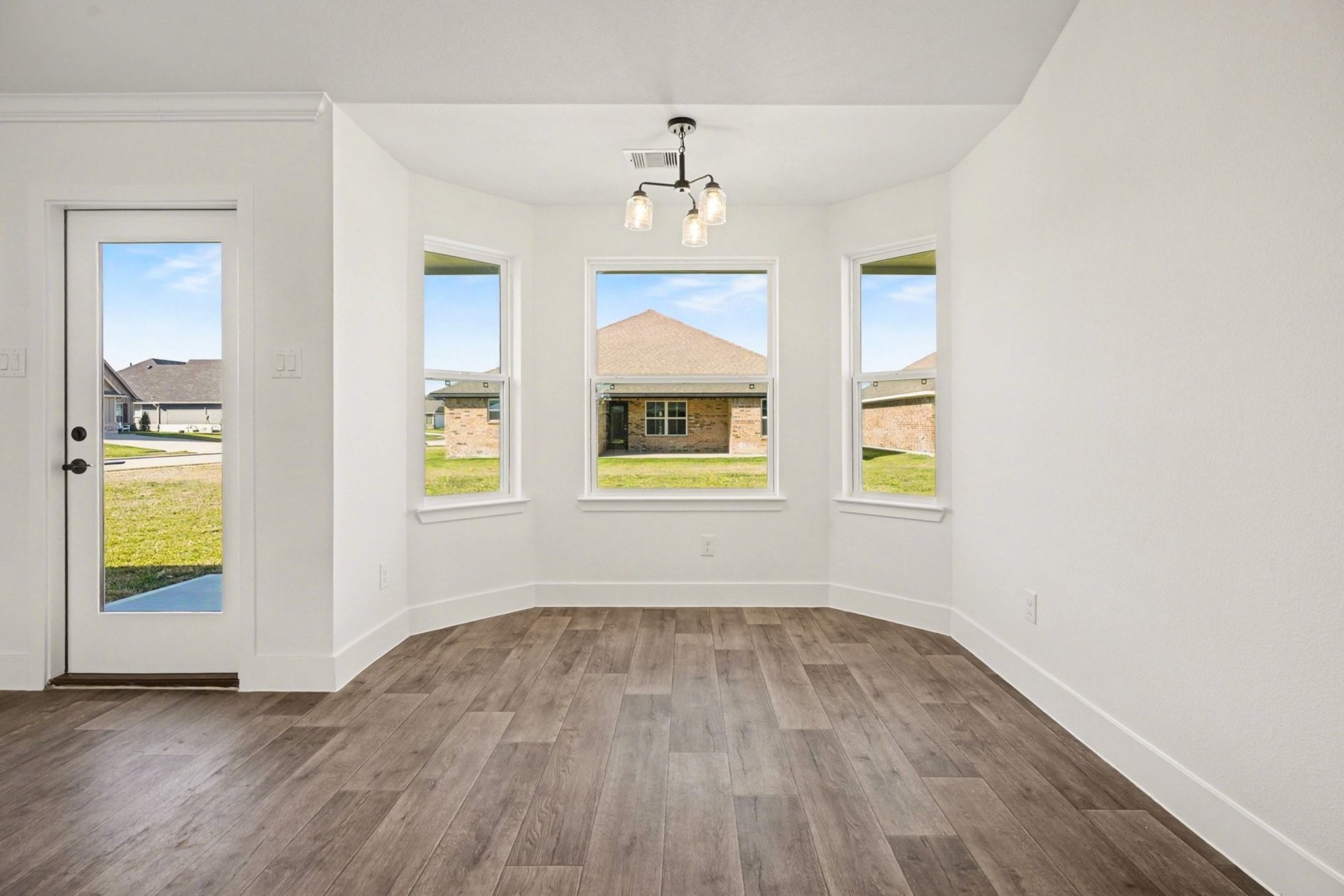 1 Keystone Court Angleton, TX 77515 - Photo 8 of 26 wooden floor in an empty room with a window