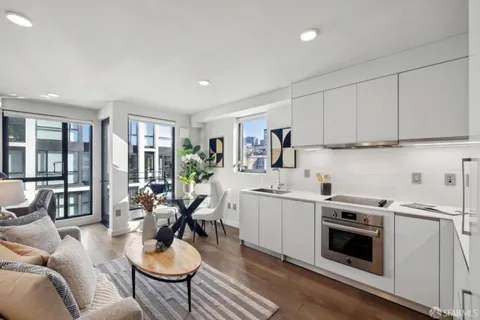 a open kitchen with stainless steel appliances kitchen island granite countertop a stove a sink a dining table and chairs