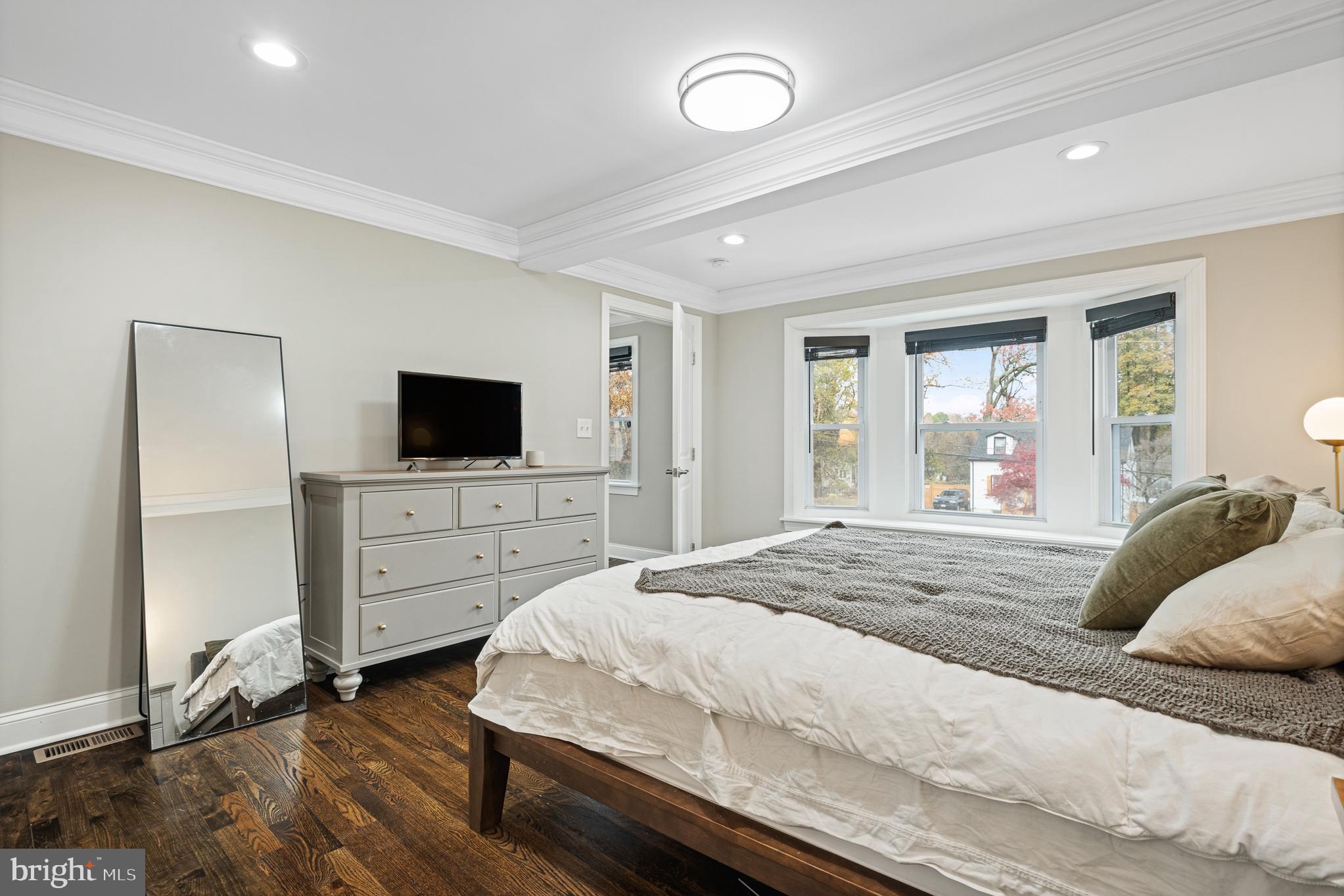 9217 Fowler Lane Lanham, MD 20706 - Photo 20 of 80 a bedroom with a bed and a flat tv screen on dresser