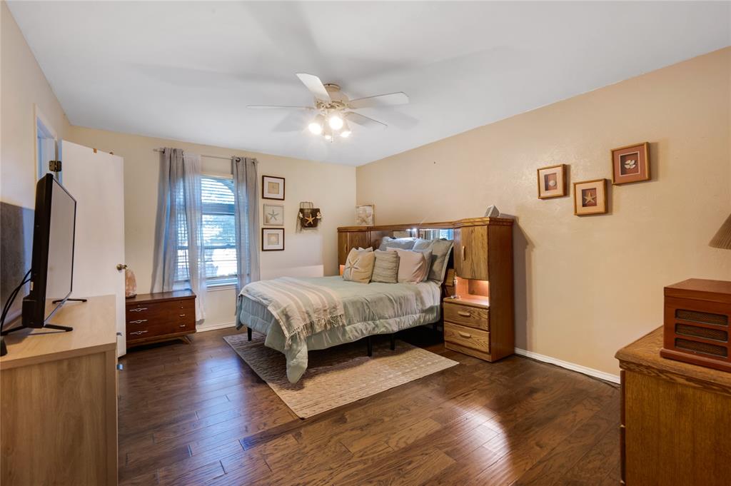 840 South Ridgeway Drive Cleburne, TX 76033 - Photo 13 of 25 Bedroom featuring dark wood finished floors and ceiling fan