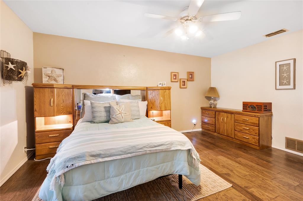 840 South Ridgeway Drive Cleburne, TX 76033 - Photo 14 of 25 Bedroom featuring dark wood-style floors and a ceiling fan