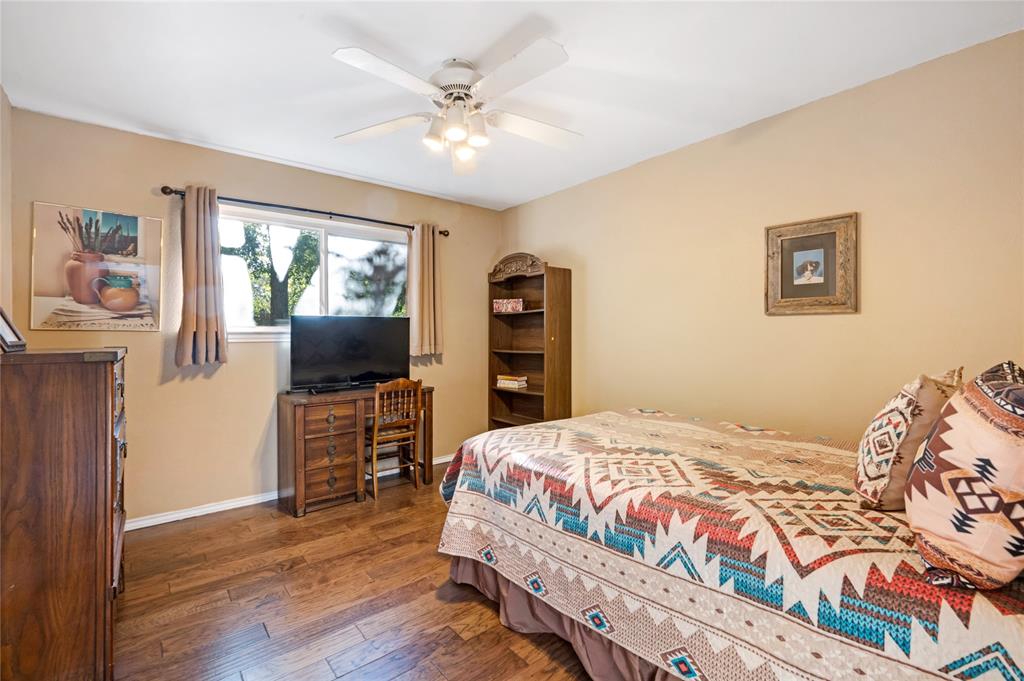 840 South Ridgeway Drive Cleburne, TX 76033 - Photo 19 of 25 Bedroom with hardwood / wood-style floors and a ceiling fan