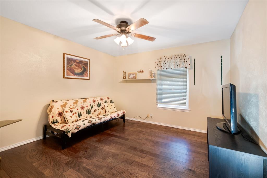 840 South Ridgeway Drive Cleburne, TX 76033 - Photo 20 of 25 Sitting room featuring dark wood-style floors and ceiling fan