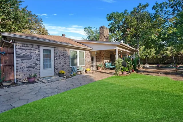 a front view of house with yard and outdoor seating