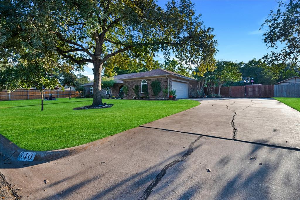840 South Ridgeway Drive Cleburne, TX 76033 - Photo 5 of 25 Ranch-style house with brick siding, driveway, and an attached garage