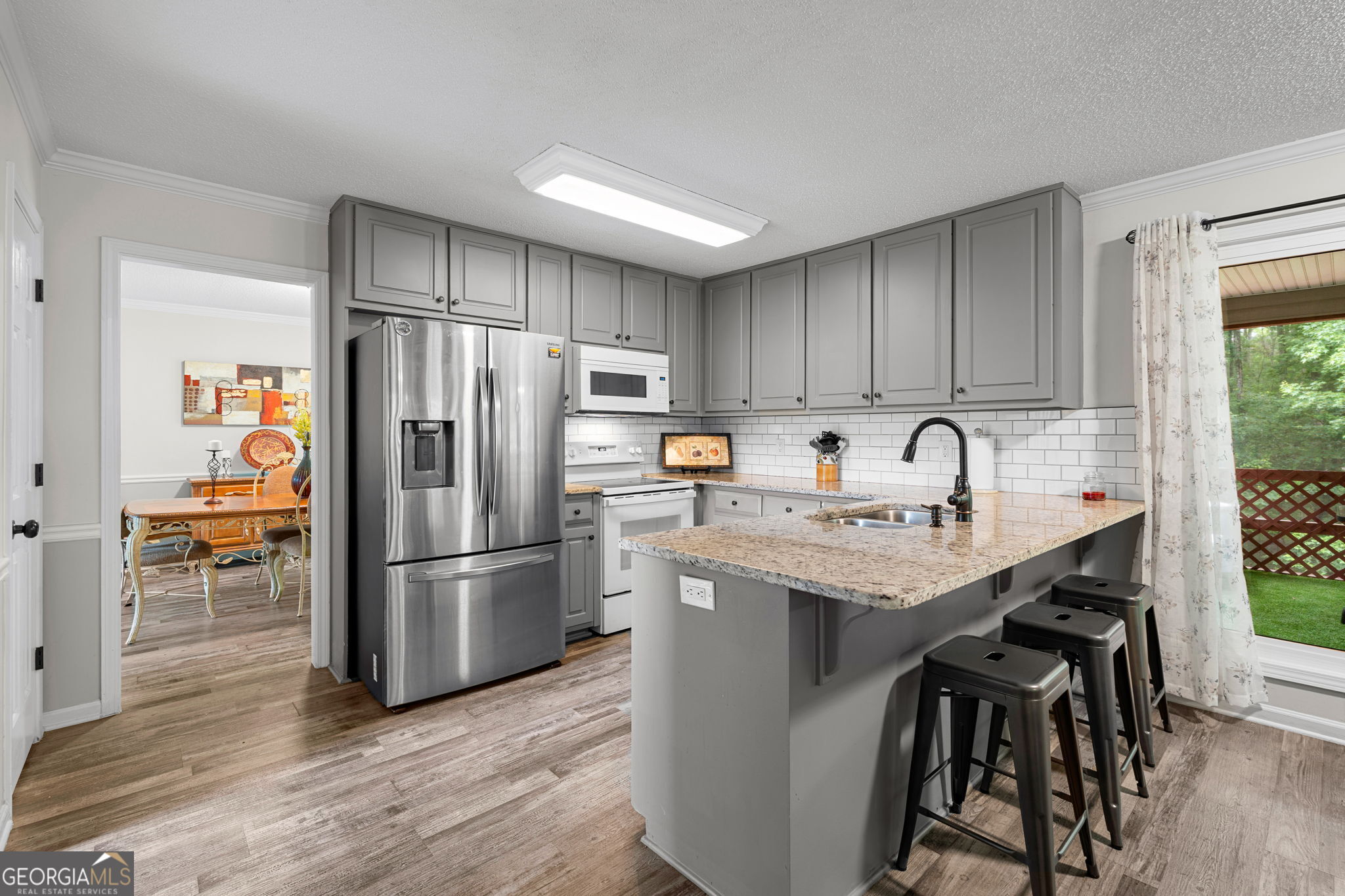 375 Gaelic Way Tyrone, GA 30290 - Photo 12 of 54 a kitchen with a refrigerator a sink and a stove top oven