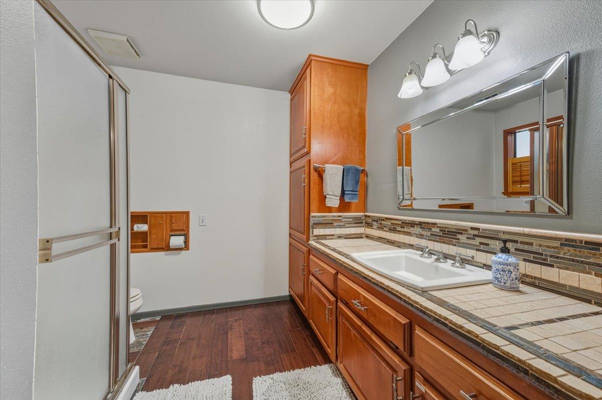 14752 Little Greenhorn Road Grass Valley, CA 95945 - Photo 15 of 35 a bathroom with a sink a vanity a mirror and a shower