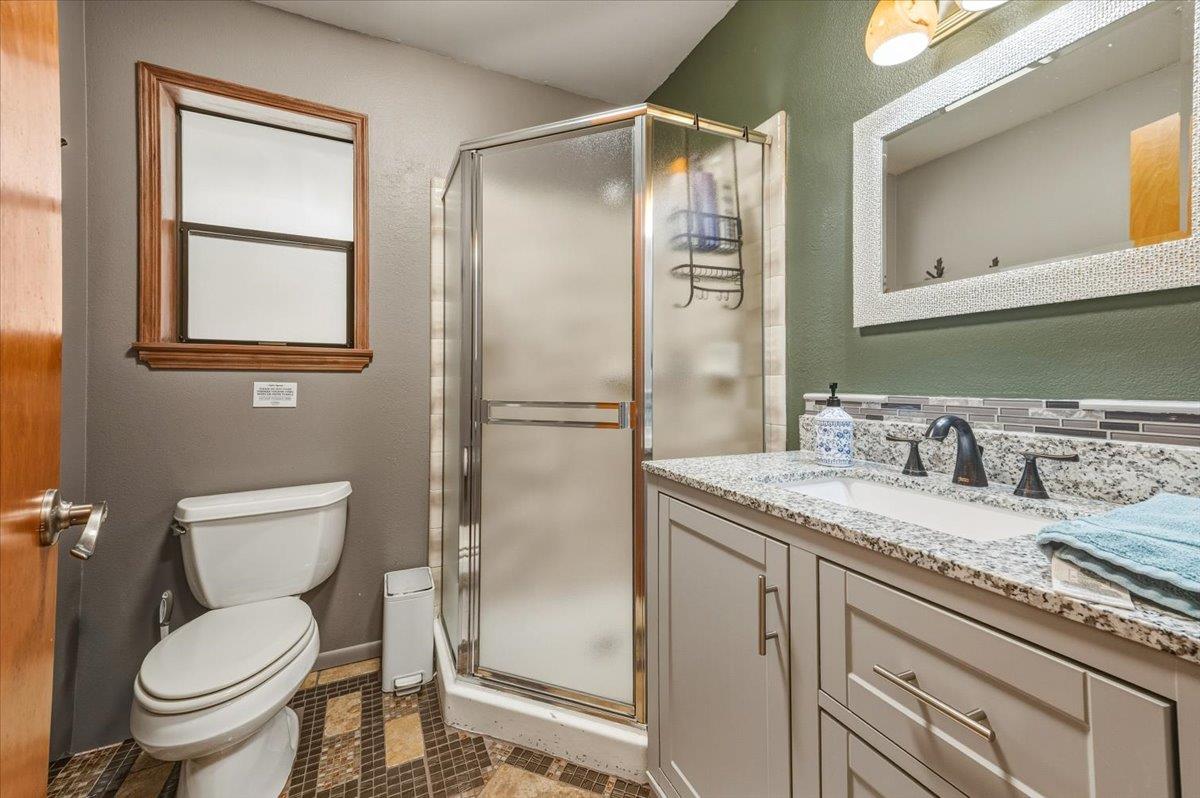 14752 Little Greenhorn Road Grass Valley, CA 95945 - Photo 18 of 35 a bathroom with a granite countertop toilet sink and mirror