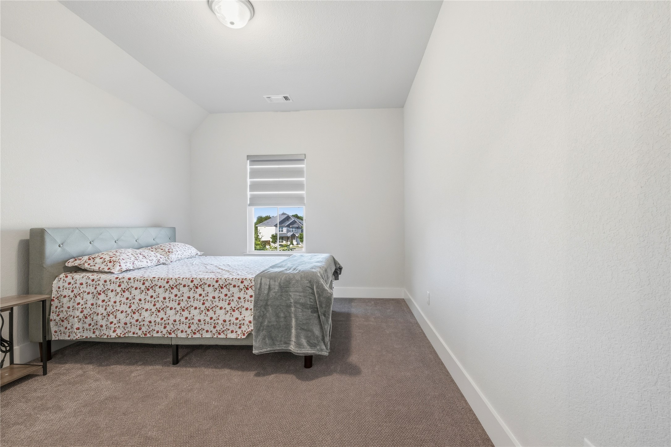 105 Autumn Oak Way Georgetown, TX 78628 - Photo 35 of 40 Carpeted bedroom featuring a single window with blinds, white walls, and a semi-flush mount ceiling light