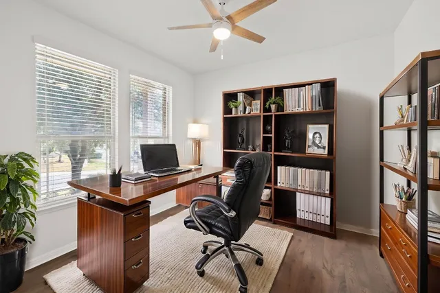 a view of a workspace with furniture and a bookshelf