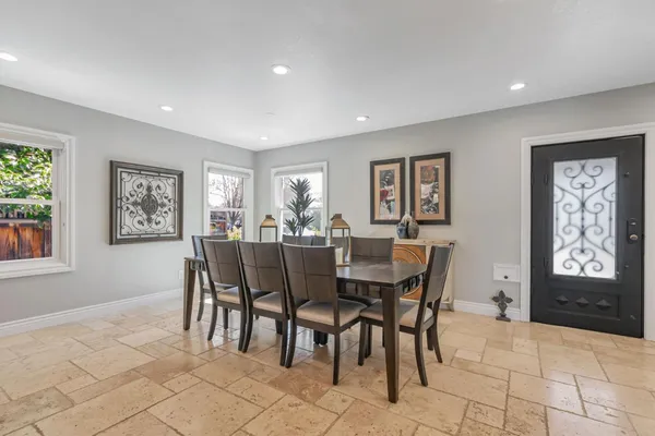 a view of a dining room with furniture and window