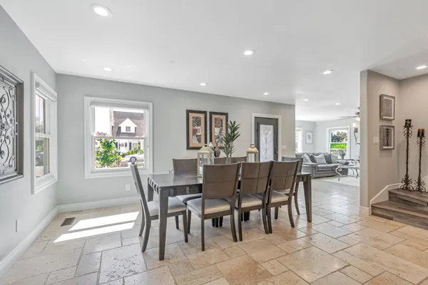 a view of a dining room with furniture and a potted plant