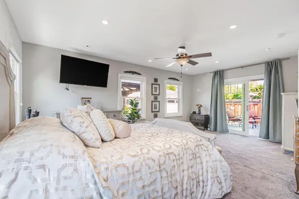 a bedroom with a large bed and a flat screen tv