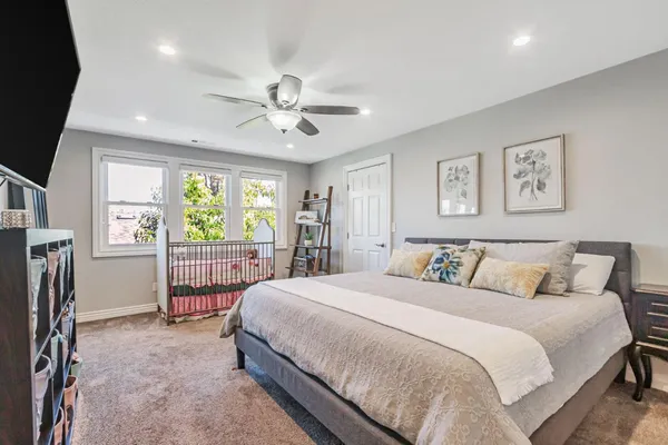 a spacious bedroom with a bed and a large window