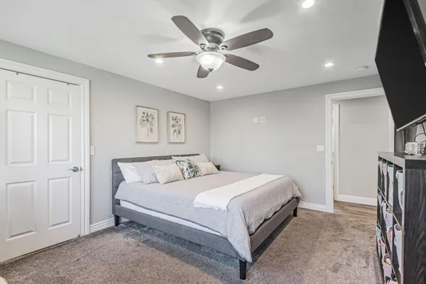 a bedroom with a bed and a ceiling fan