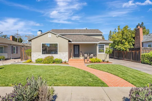 a front view of a house with swimming pool having outdoor seating