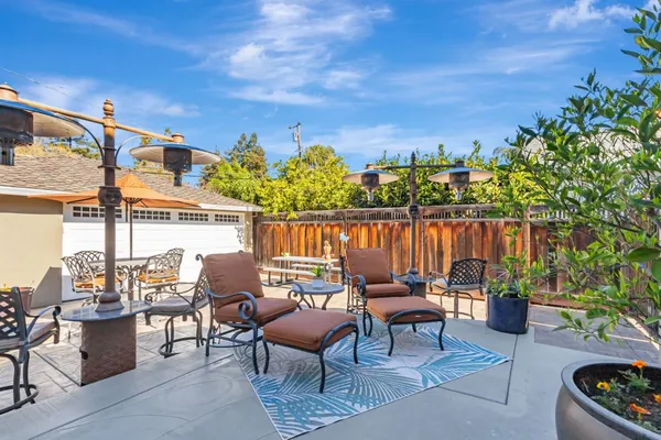 a view of a chairs and table in patio