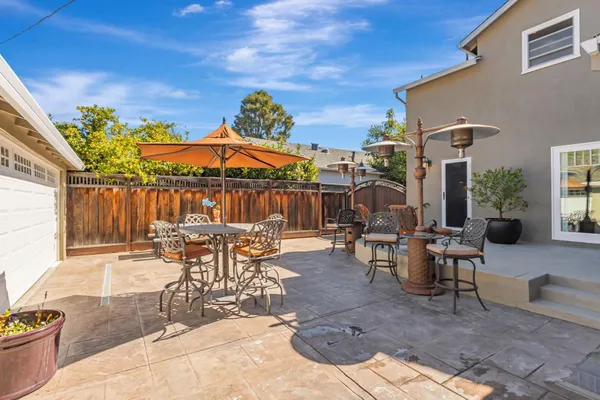 a view of a patio with table and chairs with wooden floor