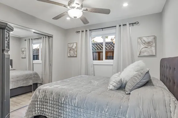 a bedroom with a large bed and a chandelier