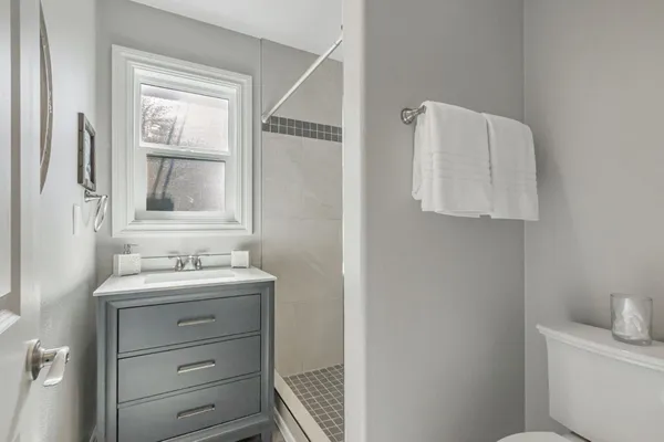 a bathroom with a sink a toilet and mirror